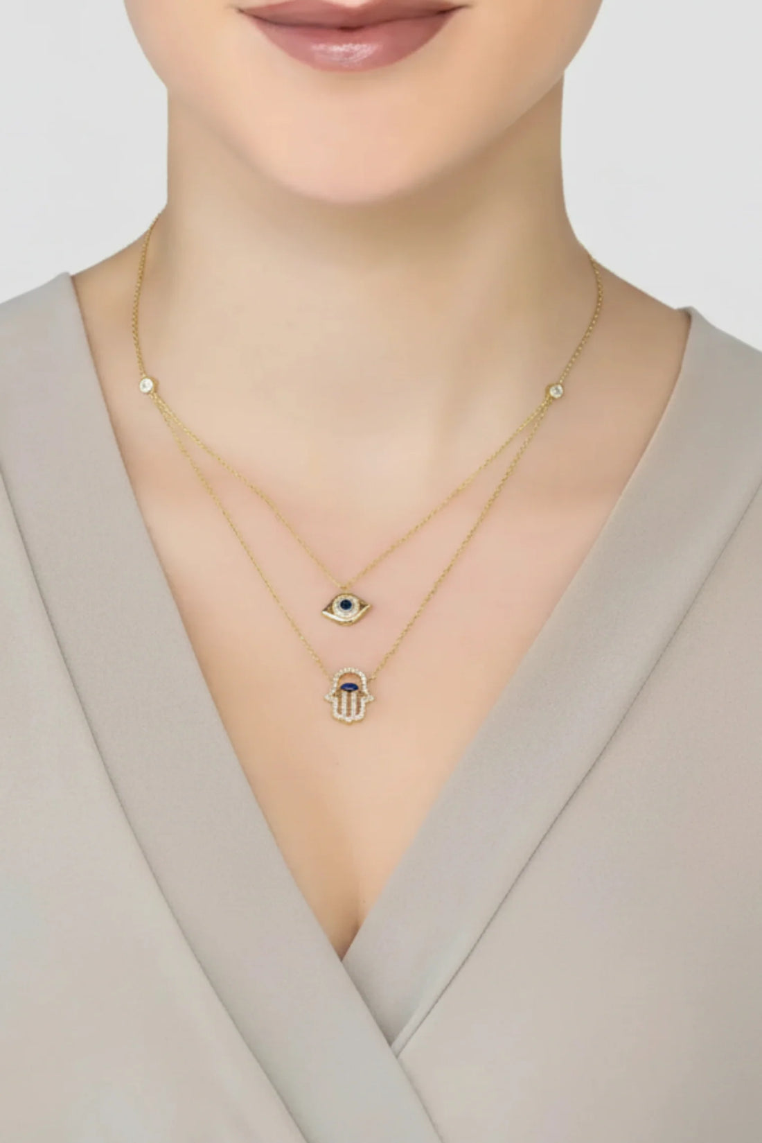 Gold layered evil eye and hamsa pendant necklace, two delicate chain layers