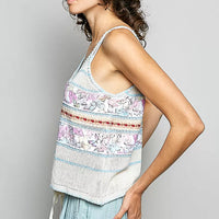 Cream and blue printed camisole with V-neck, drawstring tassels, and trim edging