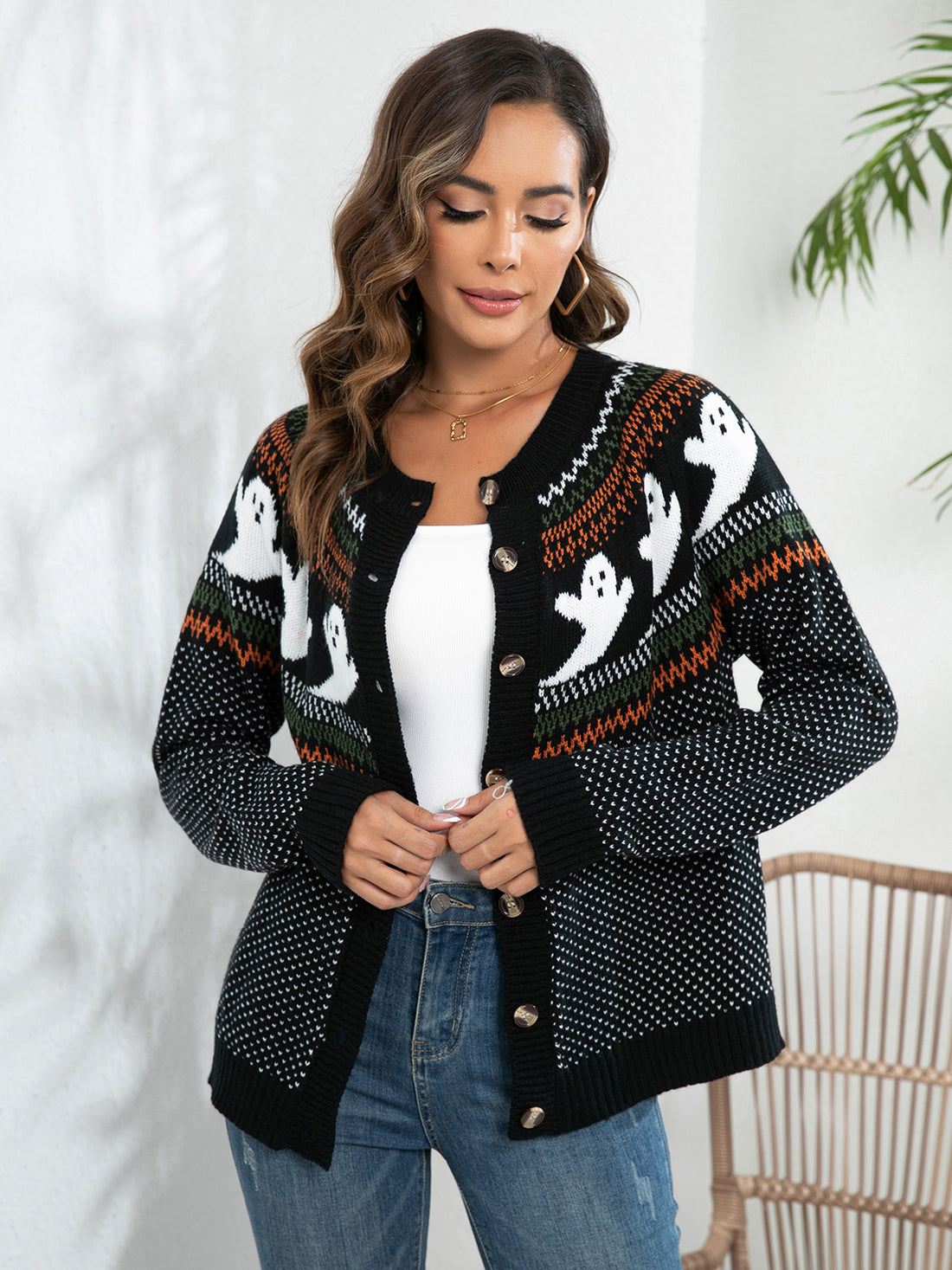 Black ghost-pattern cardigan with button front, long sleeves, and open V-neck