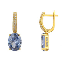 Gold oval drop earrings with blue tanzanite stones and pavé-set hinged hoops