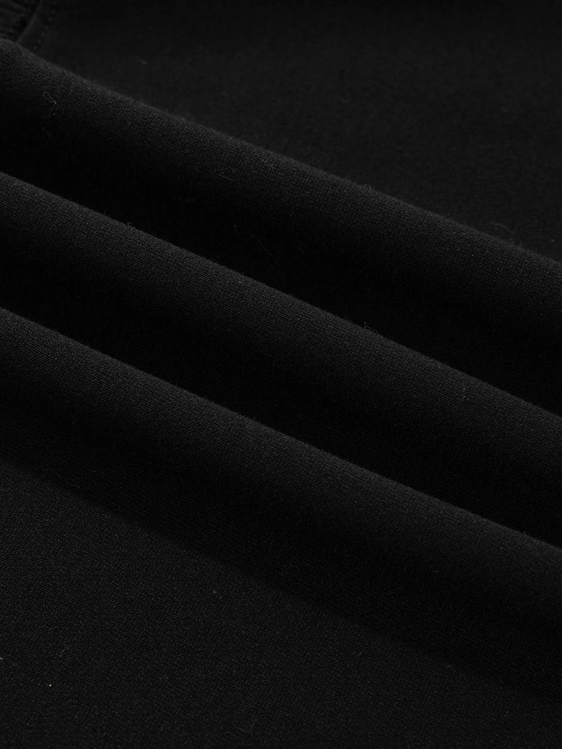 Black sweatshirt fabric close-up, smooth knit texture