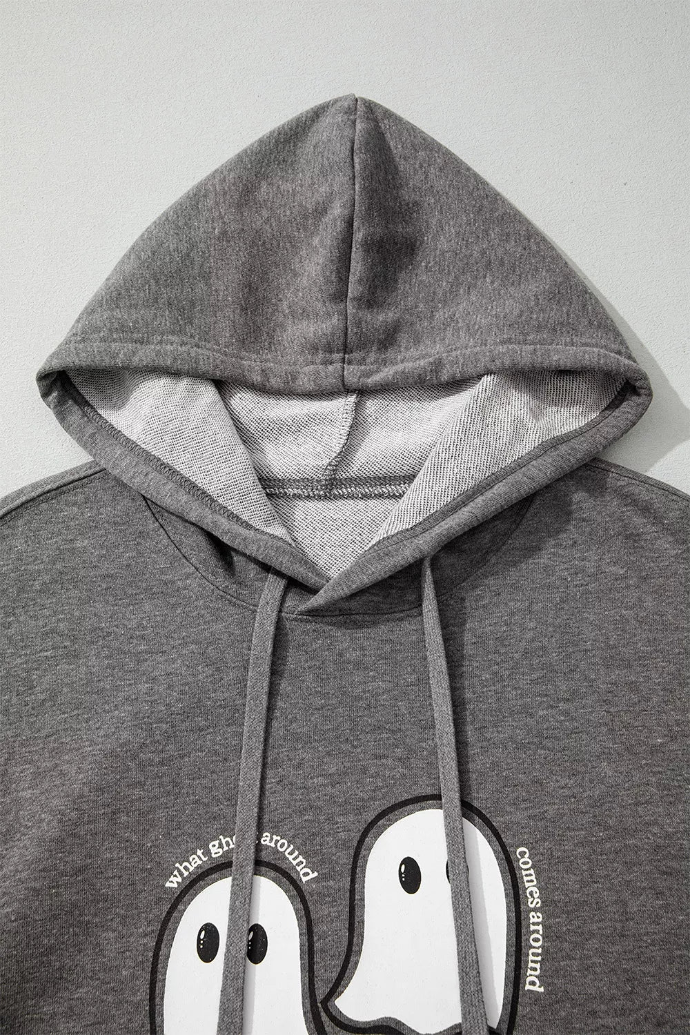 Dark gray hoodie hood and front ghost graphic detail with drawstrings and kangaroo pocket
