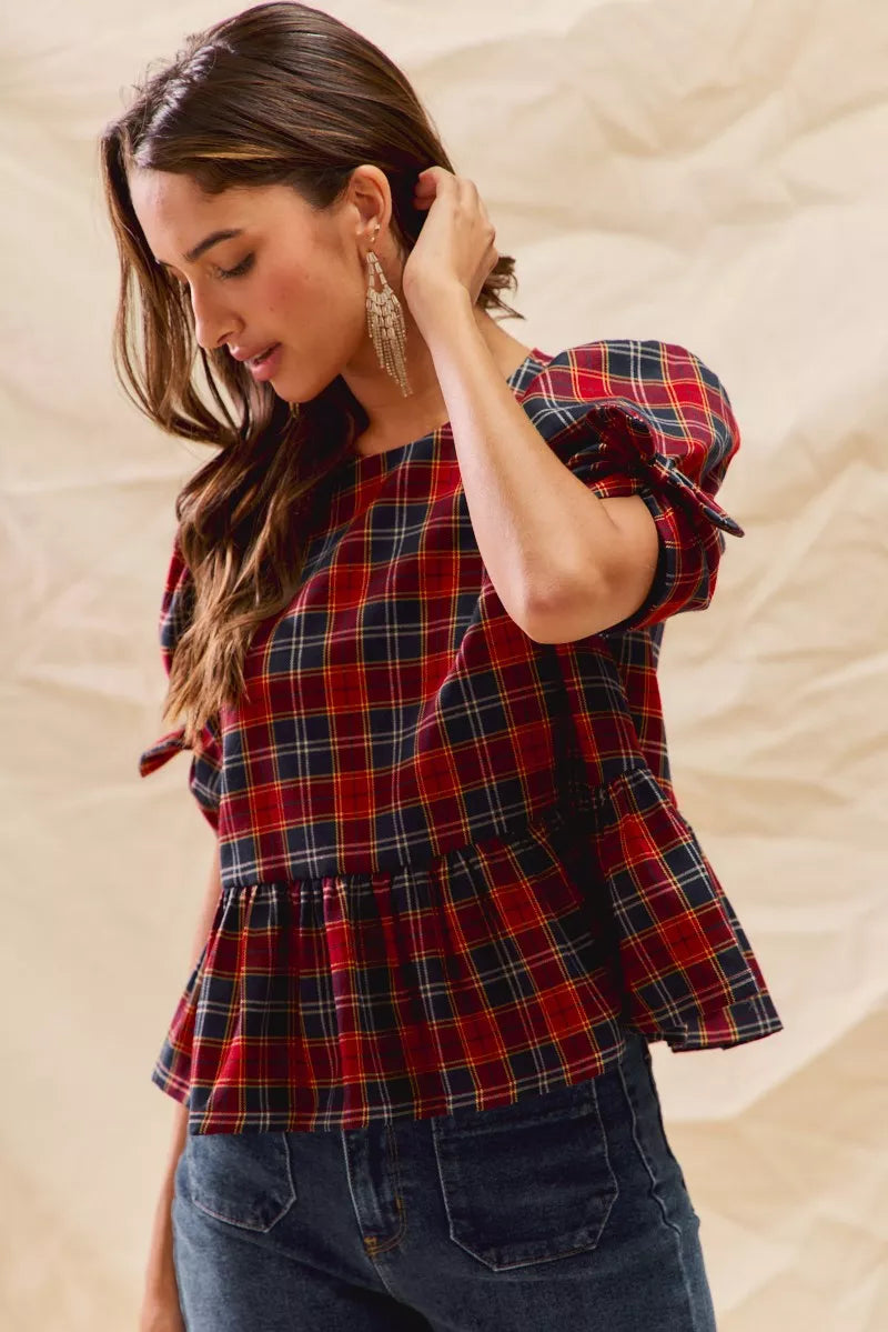 Red plaid peplum top with ribbon-tied sleeves and gathered waist detail
