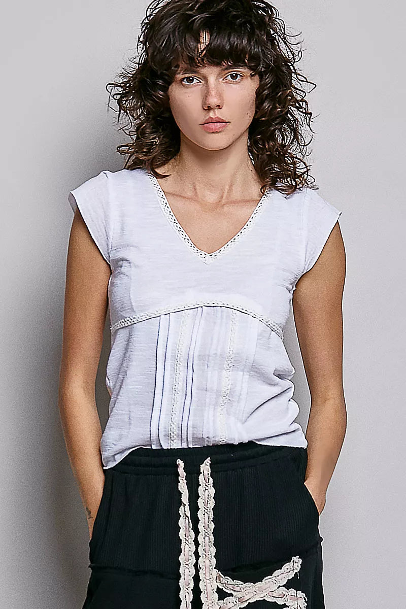Off-white textured knit V-neck short-sleeve top with lace-trim detail at neckline