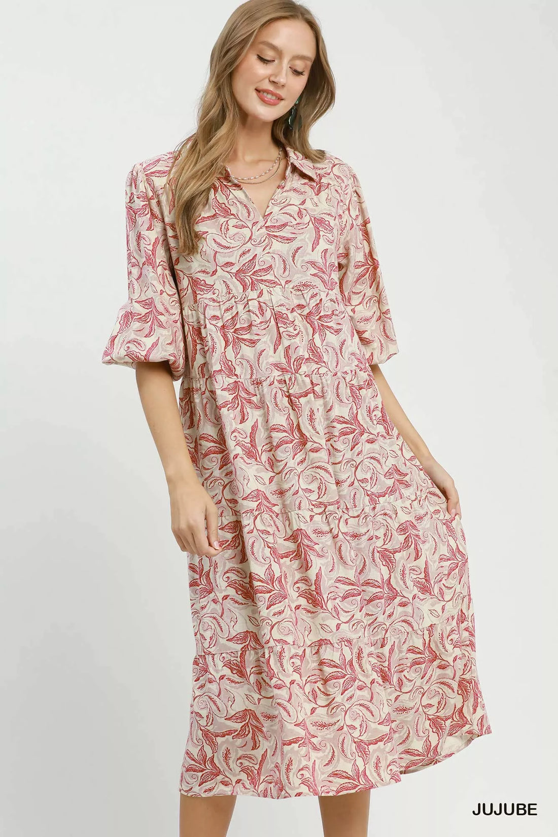 Tiered midi dress with pink botanical print, three-quarter length look, and ruffled tiers