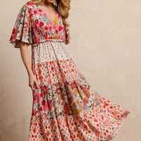 Floral print tiered midi dress with flowing skirt tiers and flutter sleeves