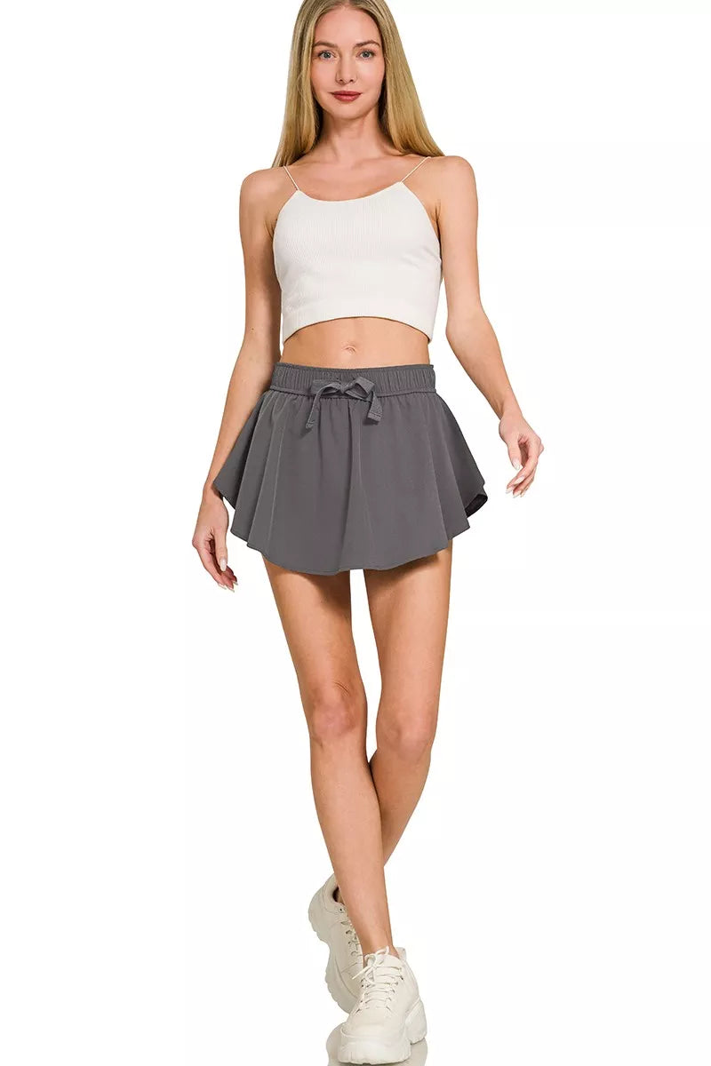 Ash grey woven active skort with elastic waistband and drawstring bow