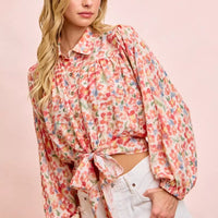 Floral print crop shirt with button front, puff sleeves, and tied hem detail