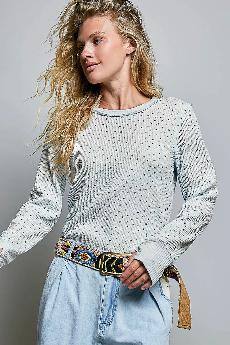 Light blue speckled crew neck long-sleeve knit top with ribbed collar and cuffs