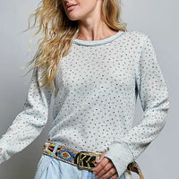 Light blue speckled crew neck long-sleeve knit top with ribbed collar and cuffs