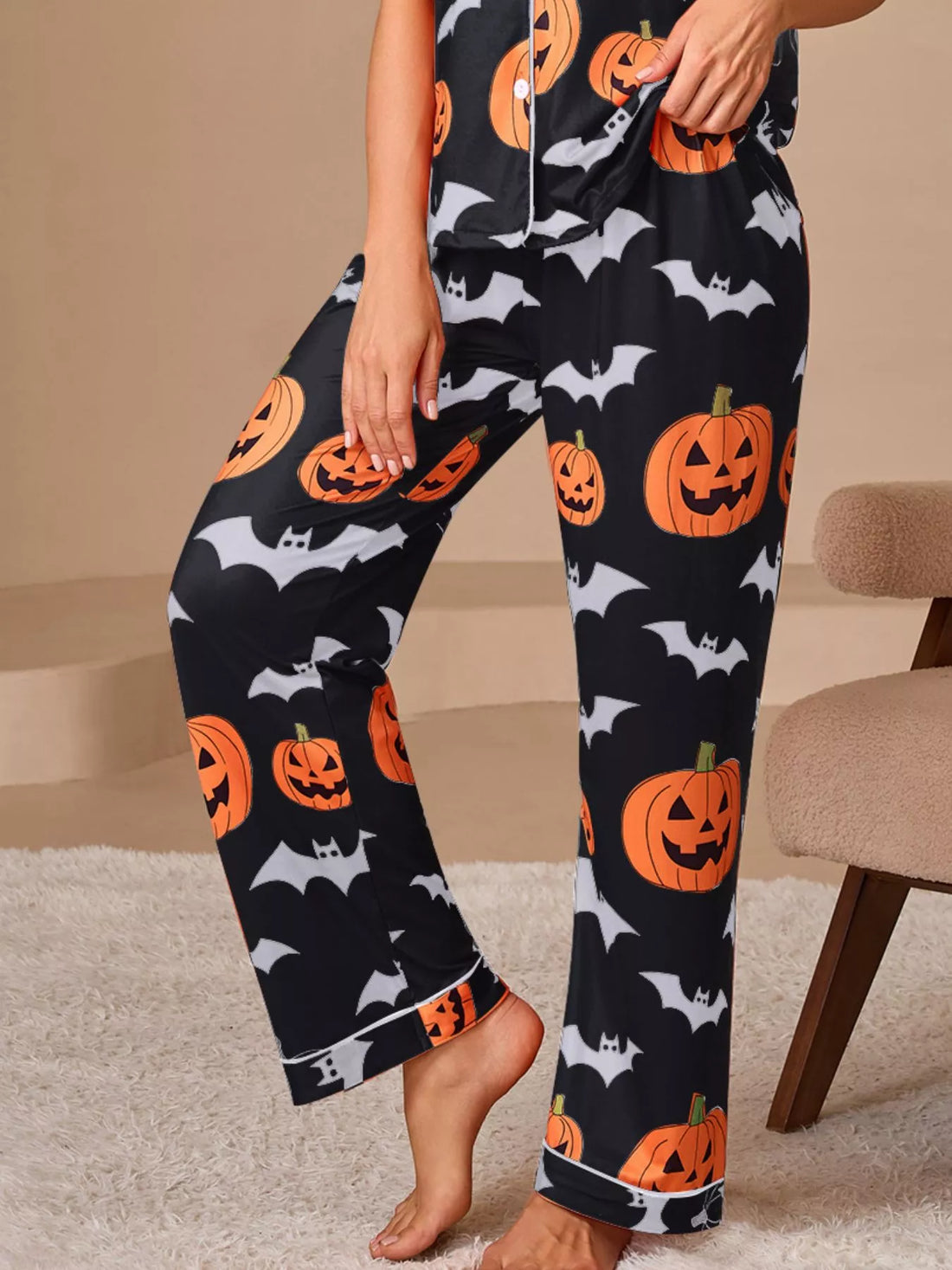 Halloween pajama set: dark navy pants with orange pumpkin and bat prints, cuffed legs