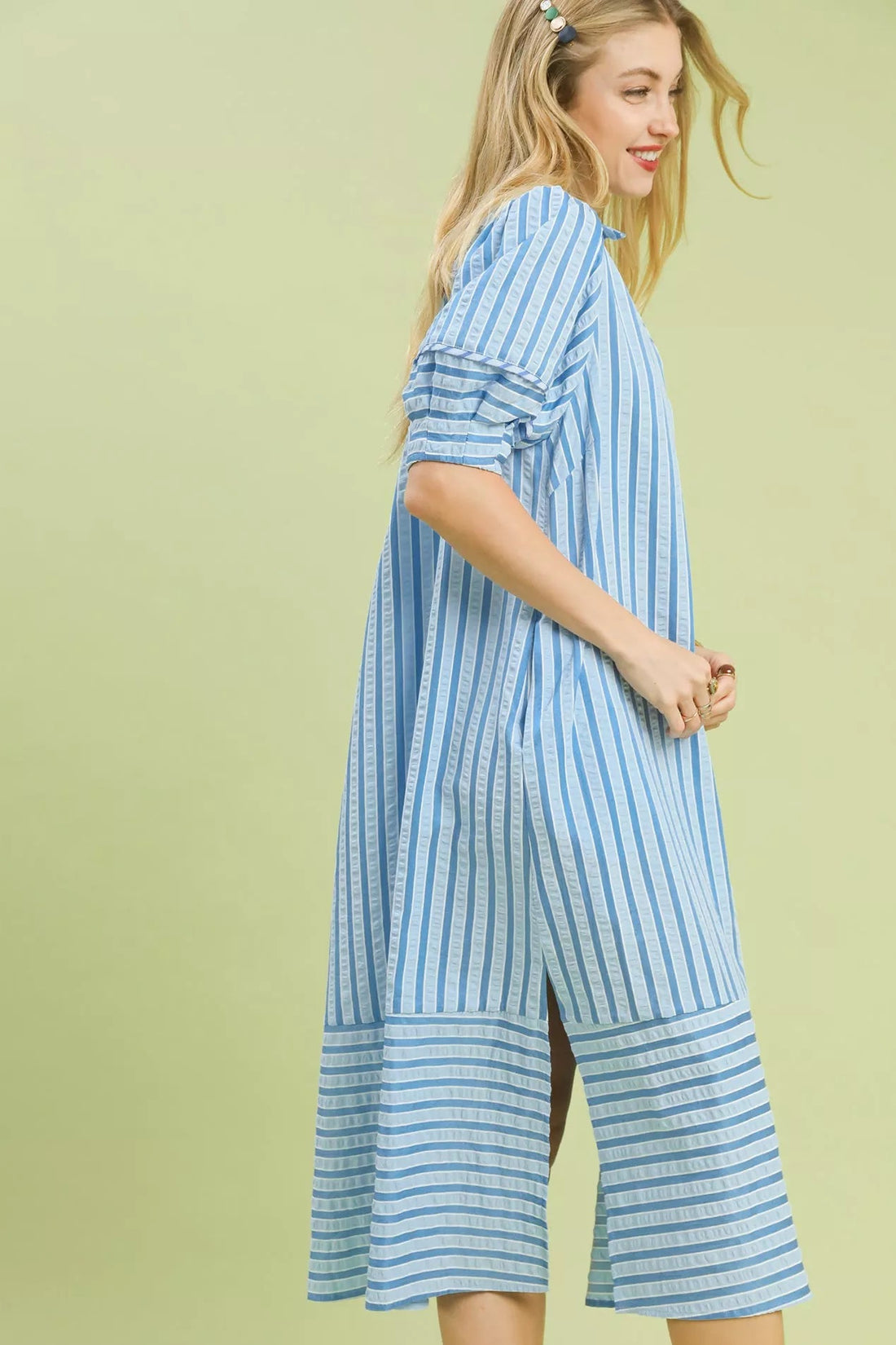Blue-and-white striped midi dress, side view with tiered hem.