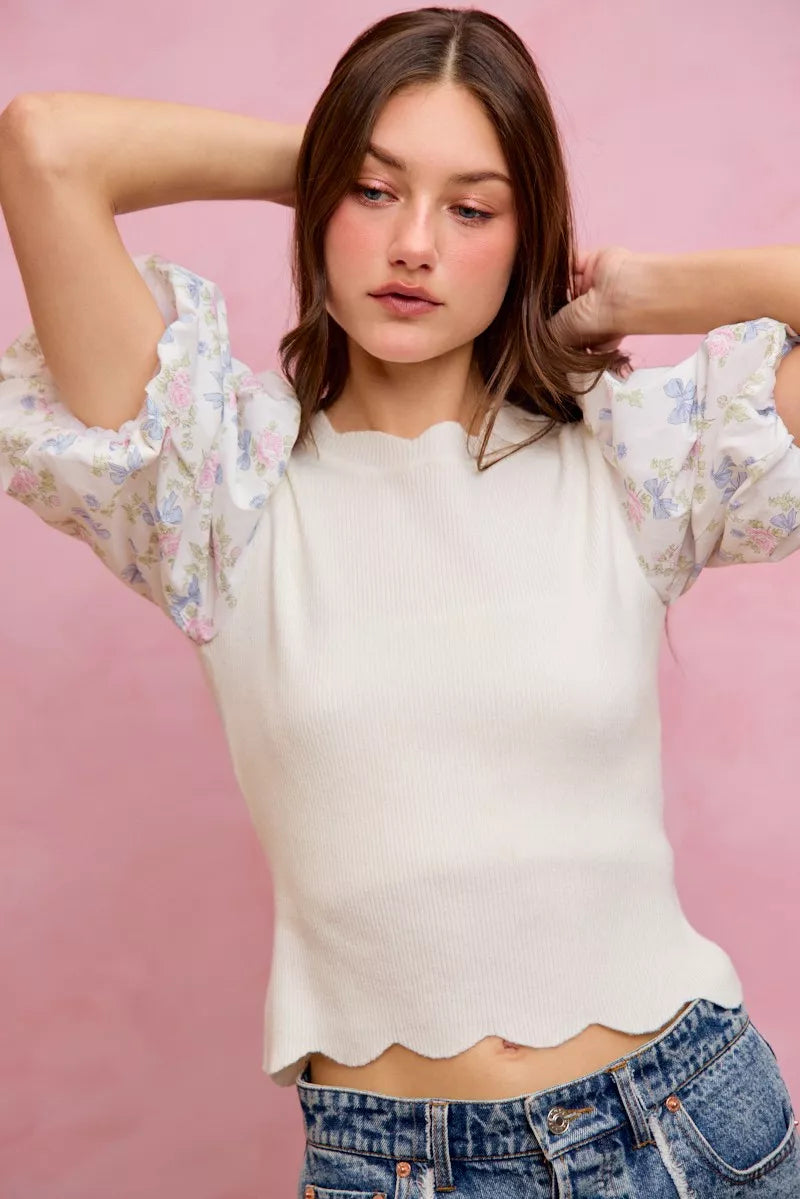 White knit sweater top with floral puff sleeves and scalloped hemline