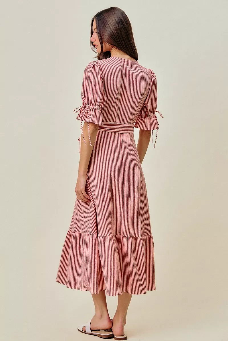 Back view of red and white striped wrap midi dress with puff sleeves and tie belt