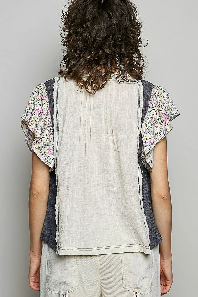 Cream blouse back with vertical seams and floral ruffle sleeves