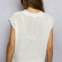 Back view of ivory popcorn knit top with round neck and cap sleeves
