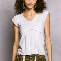 Off-white textured knit V-neck short-sleeve top with lace-trim neckline and panel