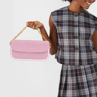 Pastel pink shoulder bag held by chain strap, with front flap and gold hardware