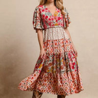 Floral print tiered midi dress with flutter sleeves, gathered waist, and midi length