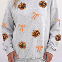 Light gray Halloween sweatshirt with orange pumpkin face and bow motifs, long sleeves