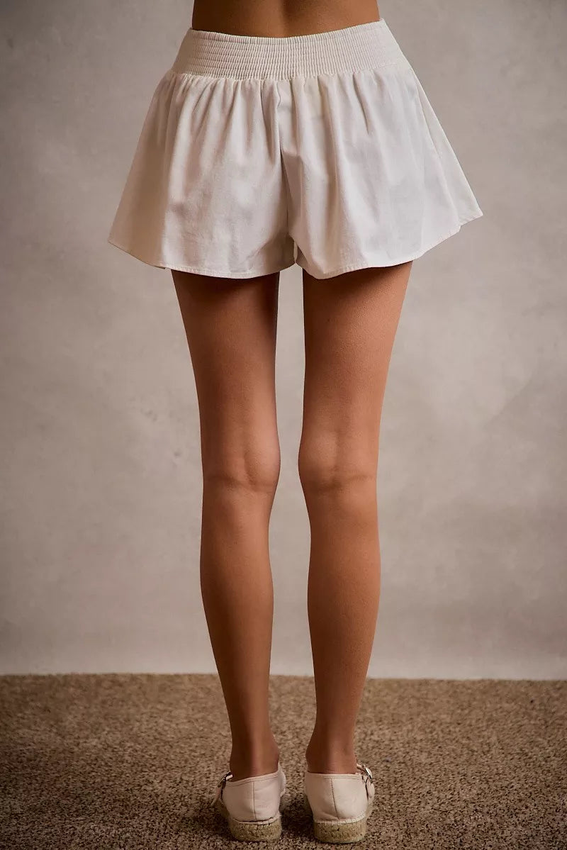 White denim skort with smocked waistband and A-line bubble hem