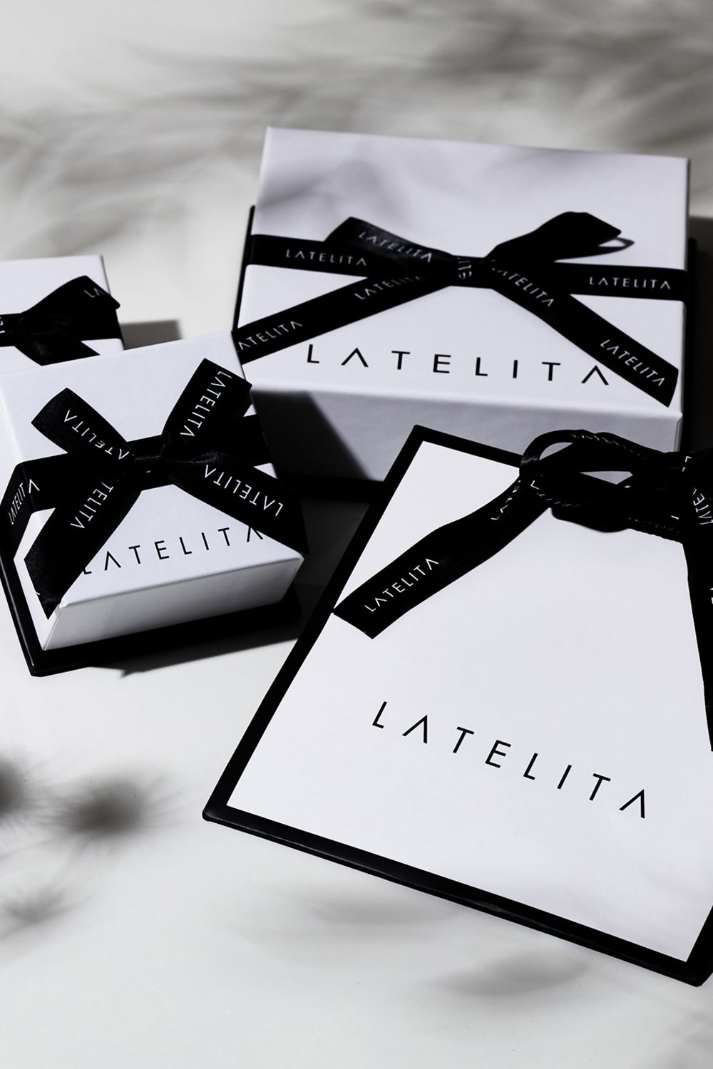 LATELITA gift boxes with black ribbon and LATELITA logo labels