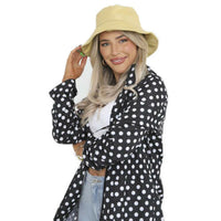 Black polka-dot rain mac with hood, long sleeves and front zip closure