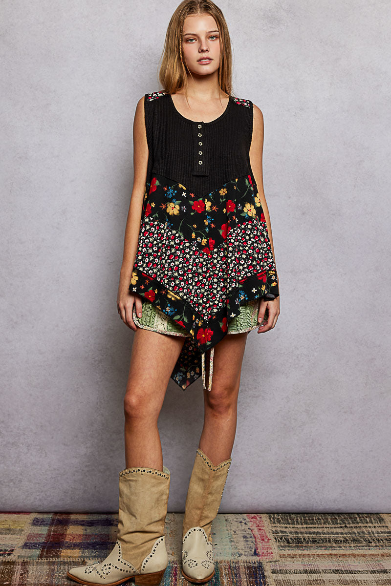 Black ribbed tank top with floral woven patch, button front and asymmetrical hem