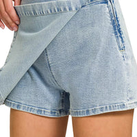 Light wash denim skort with wrap panel front and visible side tie strings