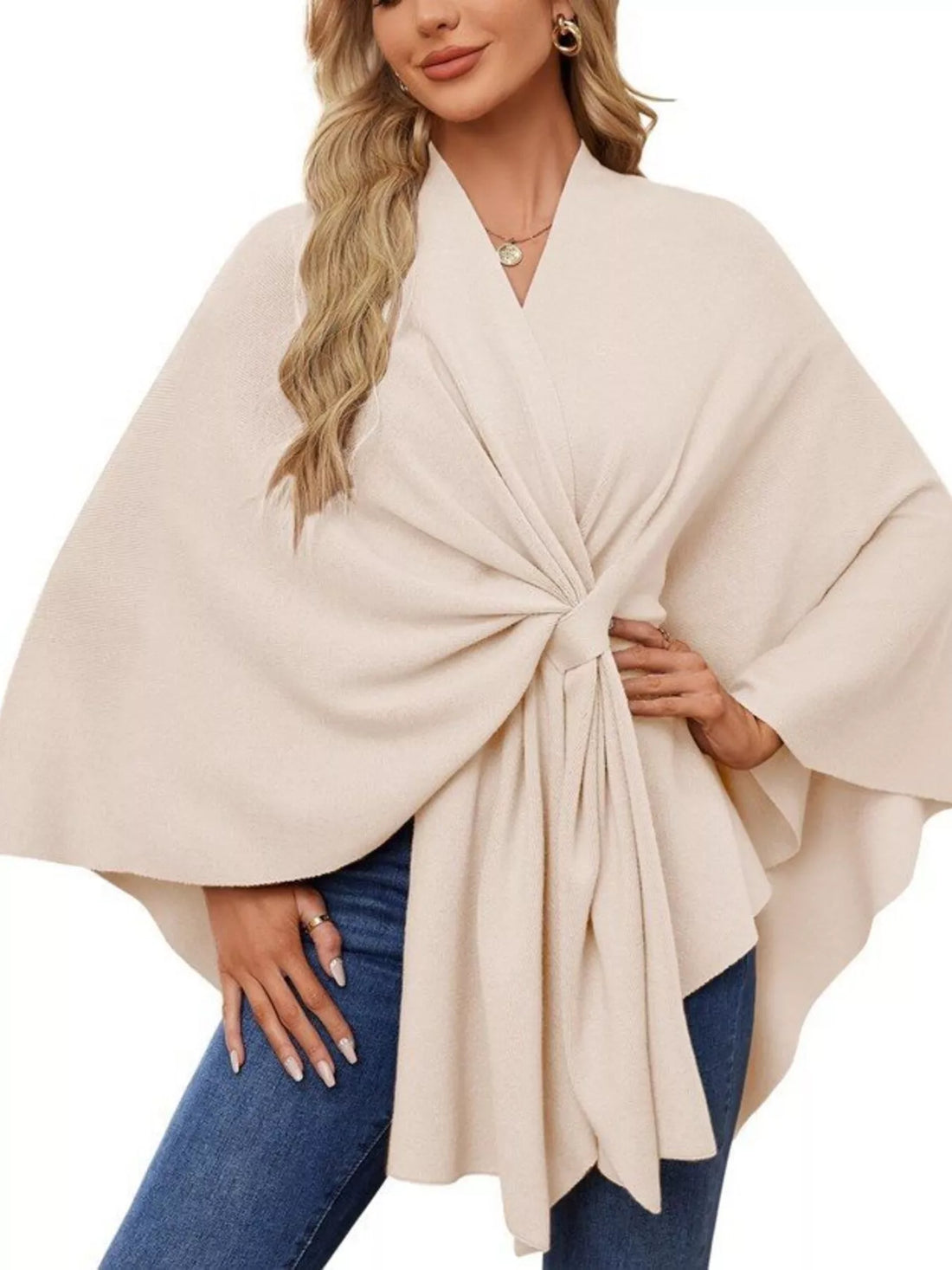 Women’s ivory shawl cape with draped V-neck and front tie detail over jeans