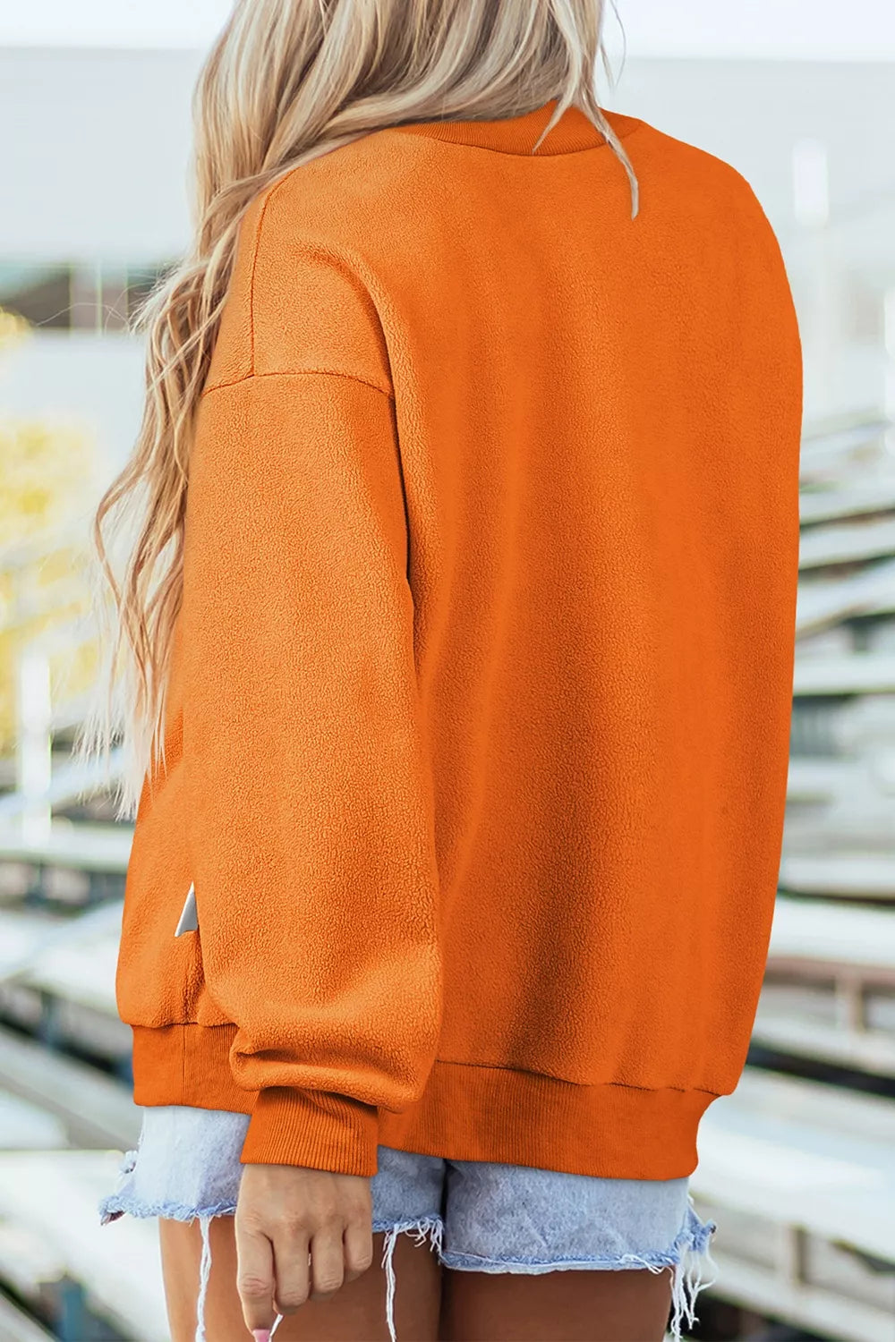 Orange mock neck sweatshirt, back view with long sleeves and relaxed fit