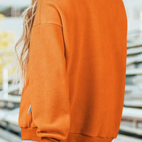 Orange mock neck sweatshirt, back view with long sleeves and relaxed fit