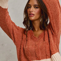 Rust chenille cable knit V-neck cropped sweater with cream ribbed cuffs
