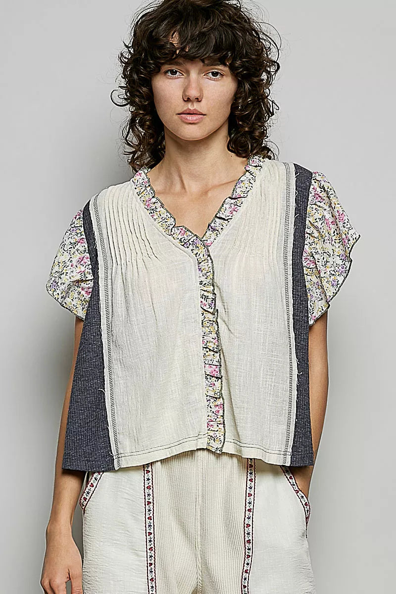 Cream linen-look V-neck blouse with floral ruffle sleeves and button front