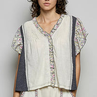 Cream linen-look V-neck blouse with floral ruffle sleeves and button front