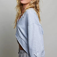 Heather gray sweatshirt side view with crossover wrap opening and long sleeves