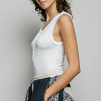 Off-white ribbed tank top with round neck and sleeveless side profile