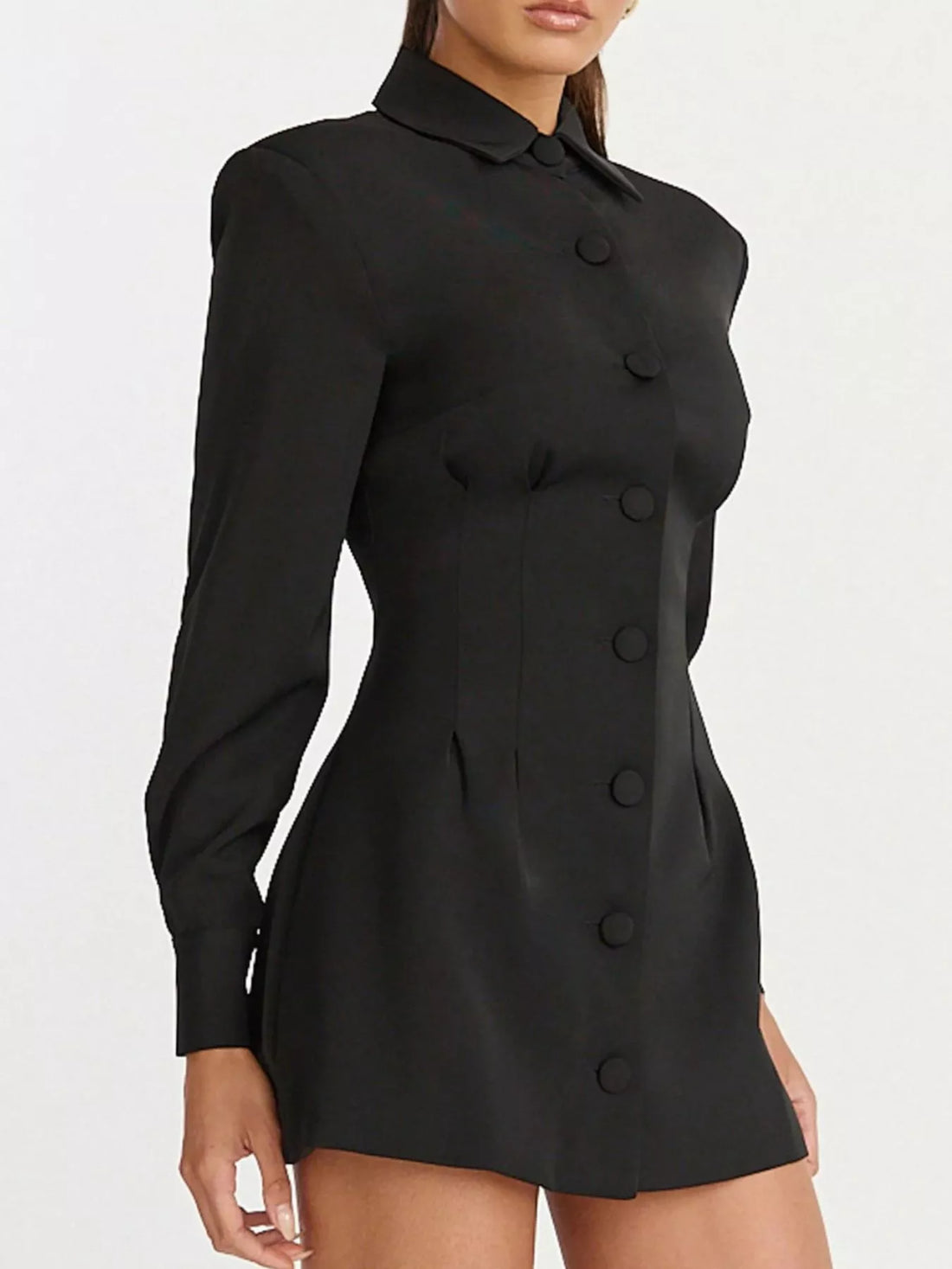 Black fitted blazer mini dress with notched collar and long sleeves, button front detail.