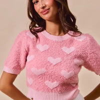Pink cropped knit sweater with all-over heart pattern, crew neck, short sleeves