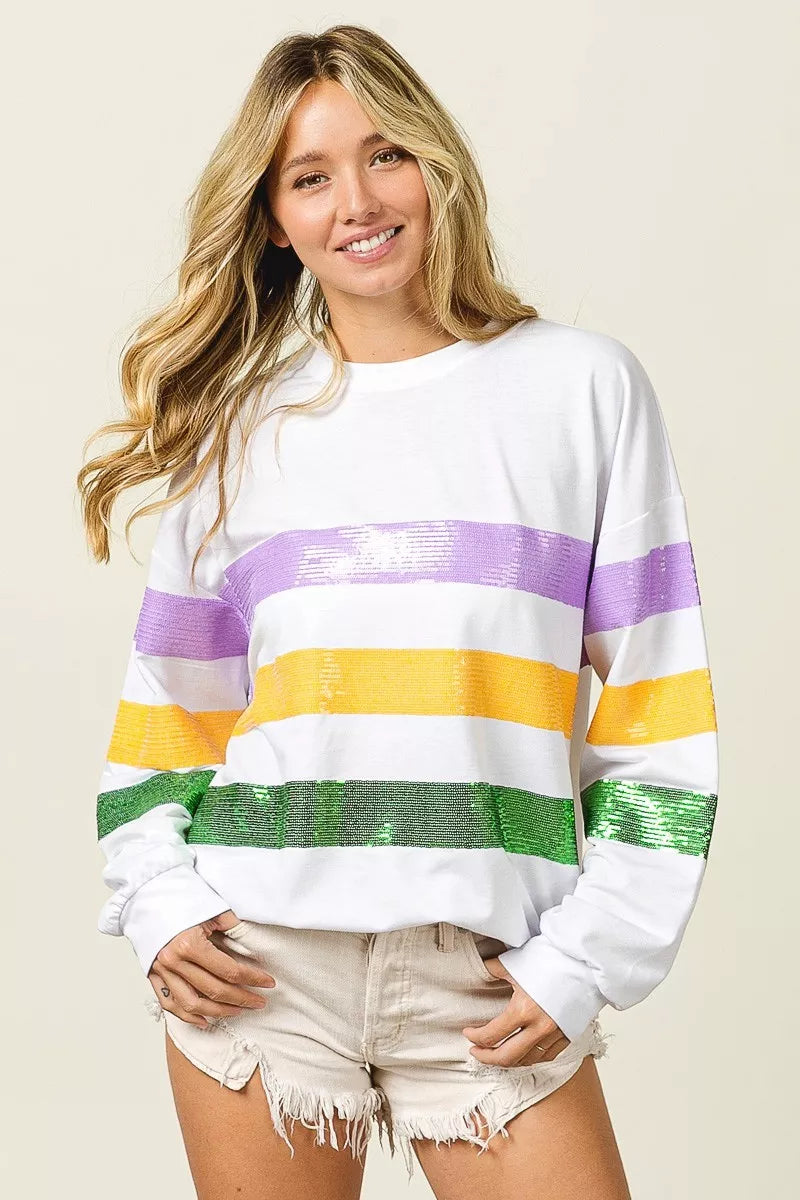 White pullover sweatshirt with sequin purple, yellow, and green horizontal stripes