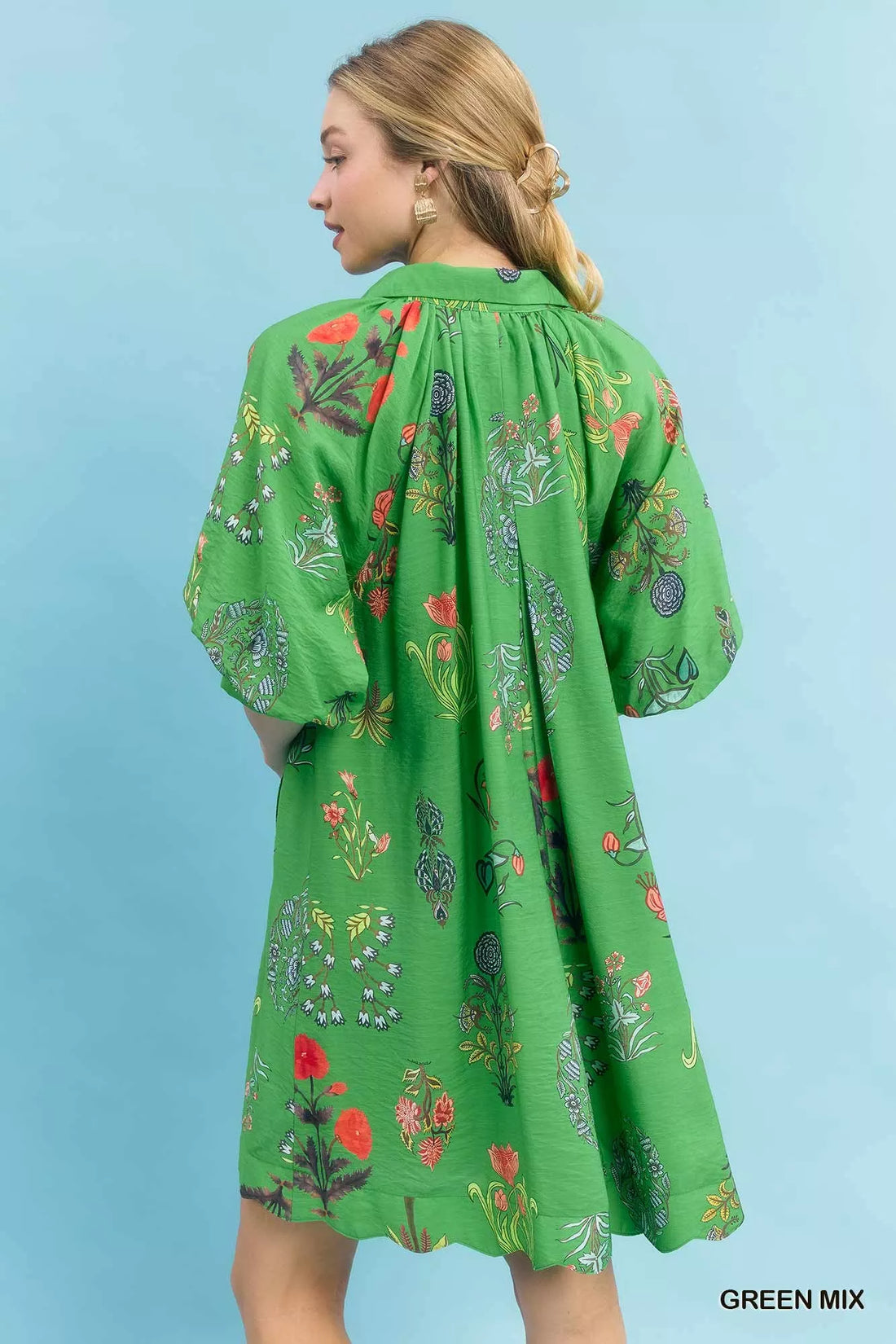Green floral mini dress, back view with gathered yoke and loose skirt silhouette
