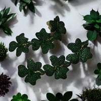 Triple drop green flower earrings, gold-tone details, close-up of textured petals