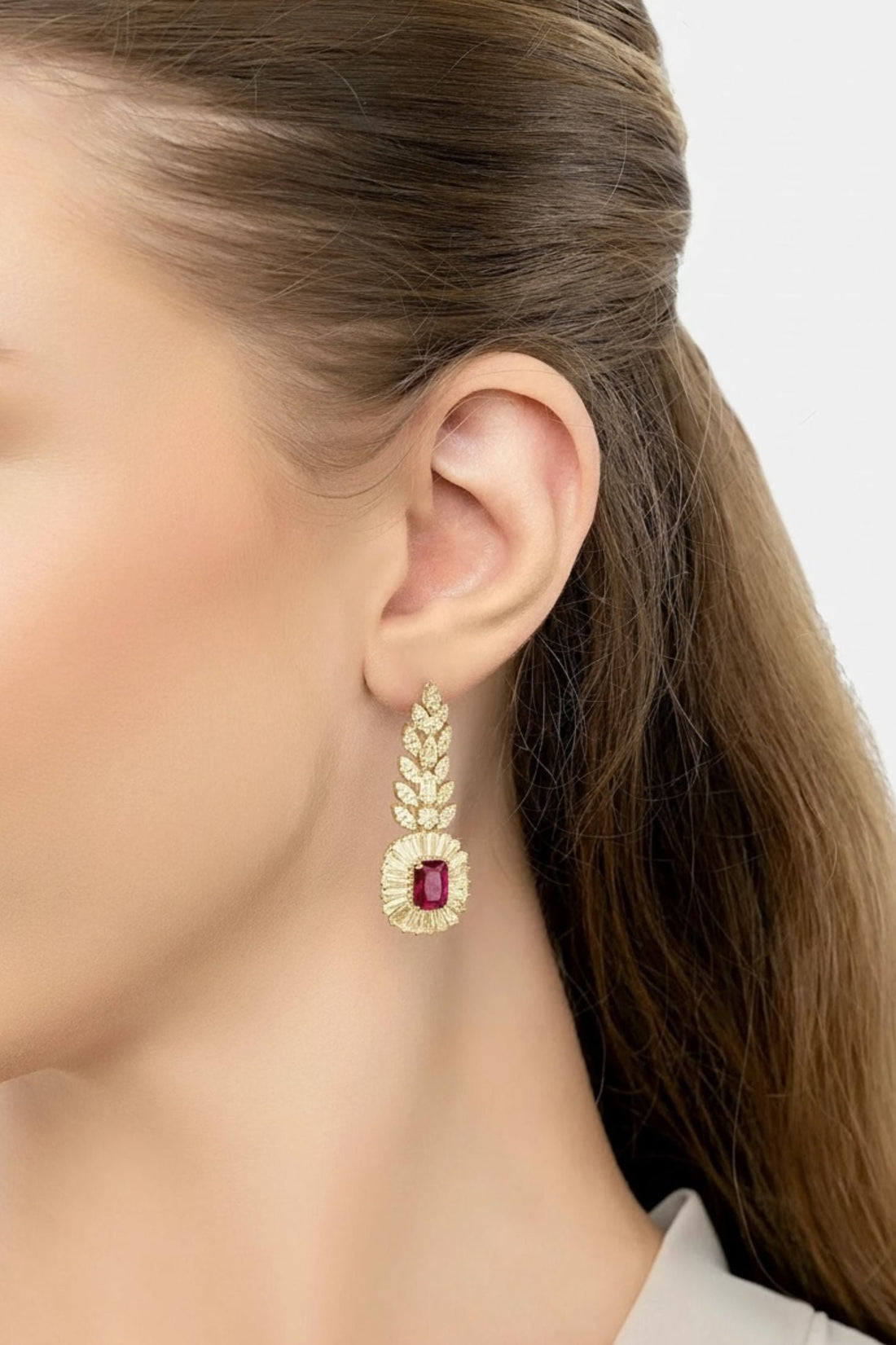 Gold-tone drop earrings with ruby-red oval center and clear stone surround