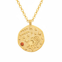 Gold-tone necklace with round zodiac-style pendant and orange gemstone detail