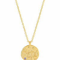 Gold zodiac talisman necklace with round Libra pendant and blue crystal, full view
