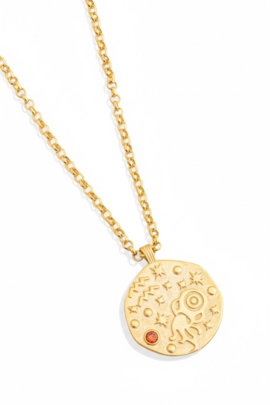 Gold-tone pendant necklace with round zodiac-style charm and orange gemstone
