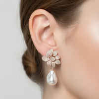 Rose gold flower stud earrings with dangling white pearl drop