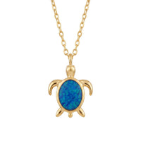 Gold sea turtle pendant necklace with blue oval opal stone and linked chain.