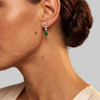 Silver triple-drop earrings with emerald-green pear drop and small crystal studs