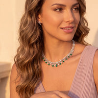 Silver-tone choker necklace with emerald-green drop stones and clear jeweled links